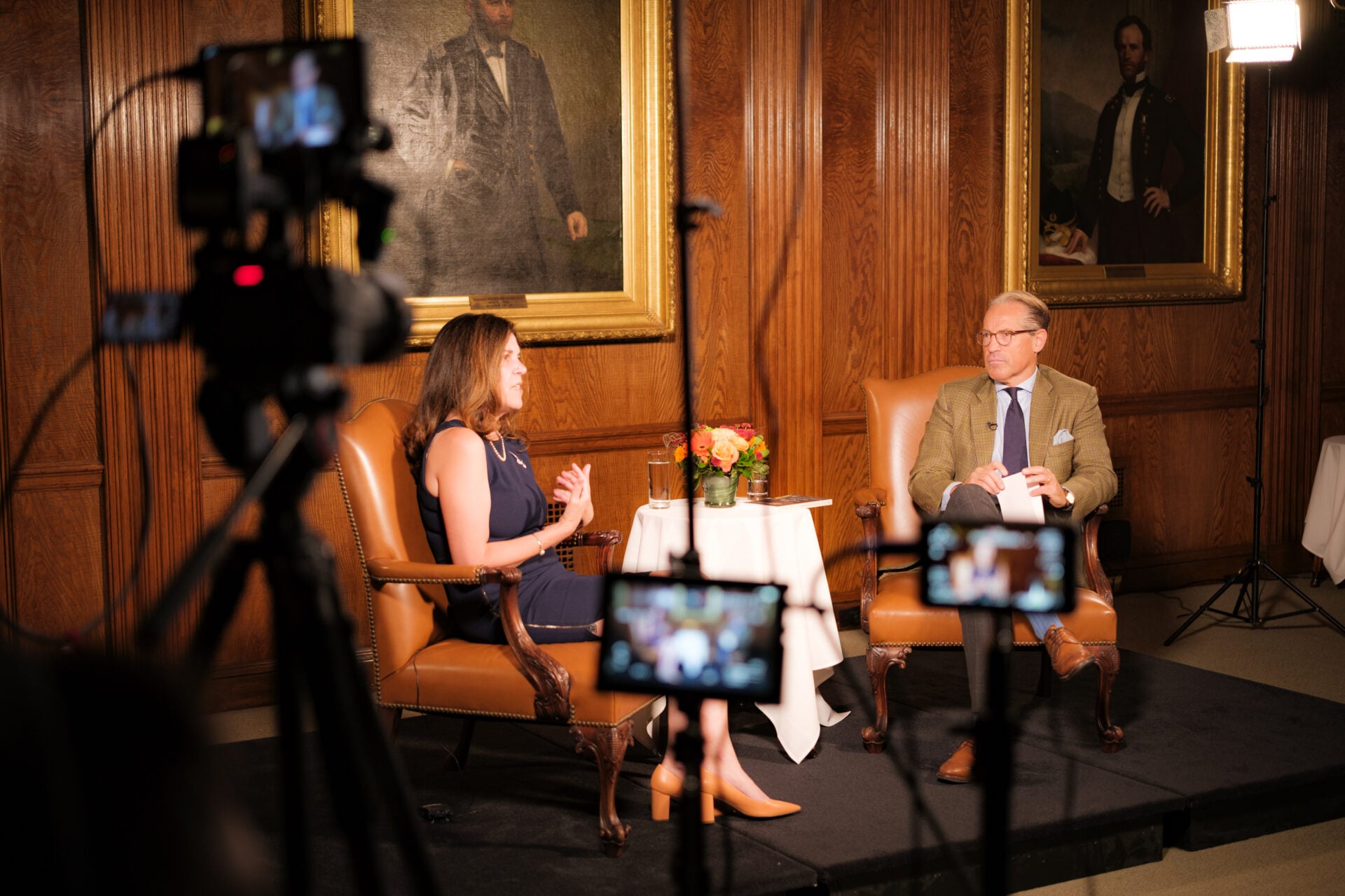 Margarita Mooney Clayton speaking on stage at a media appearance